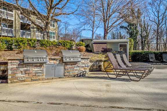 A small house with a patio and a grill.