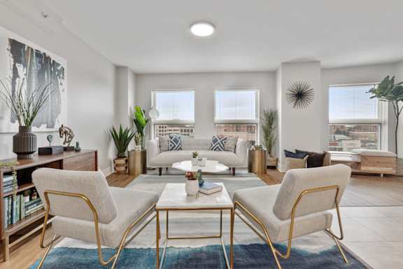 A living room with a white sofa and a coffee table.