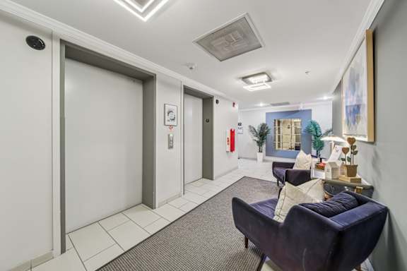Furnished elevator lobby and resident seating area at River 595 in Des Plaines