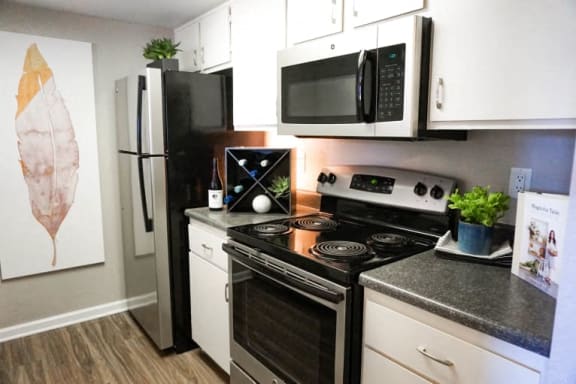 a kitchen with a stove microwave and refrigerator
