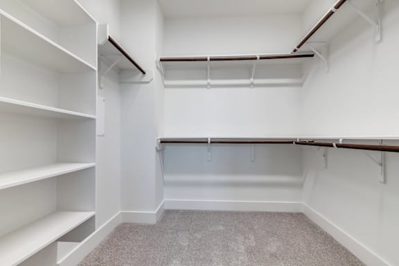 Empty white shelves in a room.