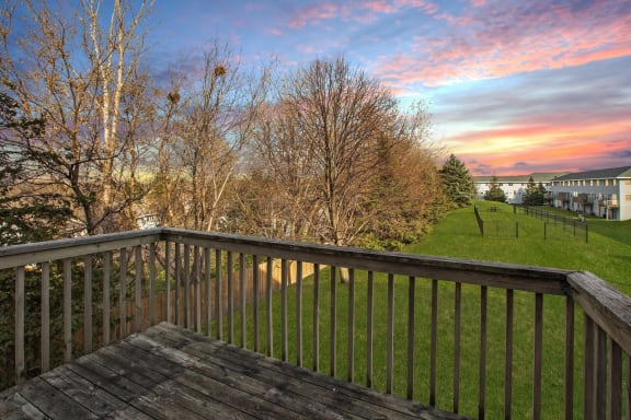 Summit Townhomes in Burnsville, MN photo of the view from the deck of a townhome with a sunset