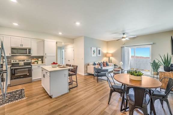 A modern kitchen with a dining table and chairs.