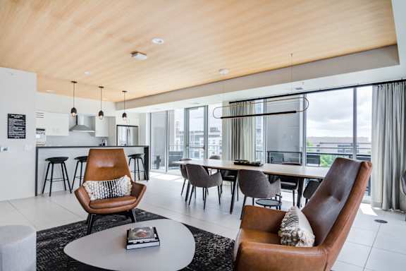 A modern living room with a brown leather chair and a white coffee table.