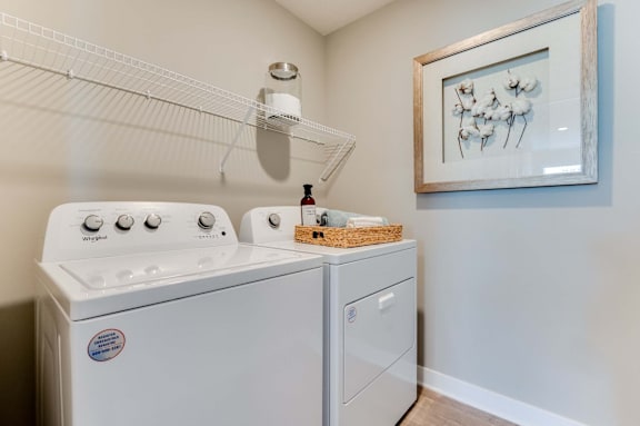 A white dishwasher and stove in a small kitchen.