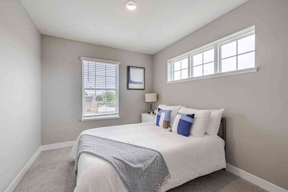 A bedroom with a large bed and a window.