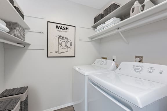 Hinton Heights Apartments in Cottage Grove, MN photo of a washer and dryer in a white laundry room