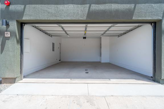A garage with a white interior and a red light on the left side.