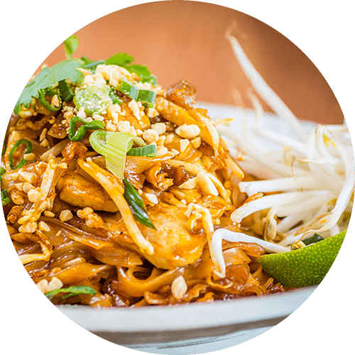 A plate of food with noodles, meat, and garnish.