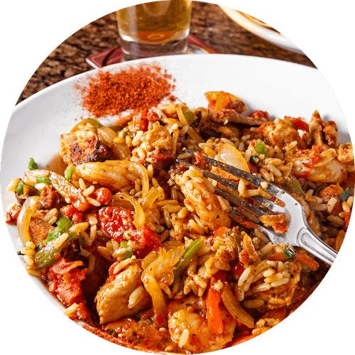 A plate of food with rice, chicken, and vegetables.