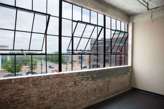 a view of the city from a window in an empty room
