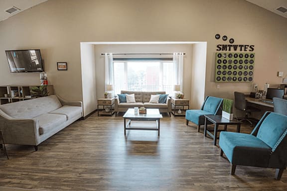 A living room with a couch, chairs, and a coffee table.