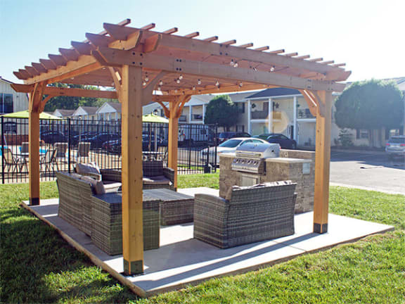 grilling area with pergola and patio furniture.