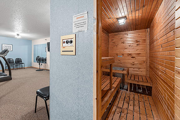 A room with a sauna and a gym.