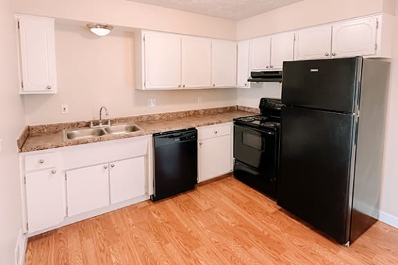 a kitchen with black appliances and white cabinets