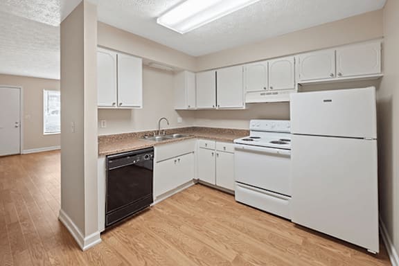 A kitchen with white appliances and cabinets.