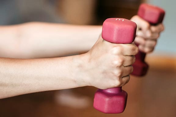 a person holding a dumbbell in their hands