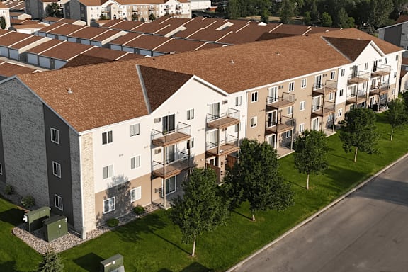 Apartment complex with brown roofs and white walls.