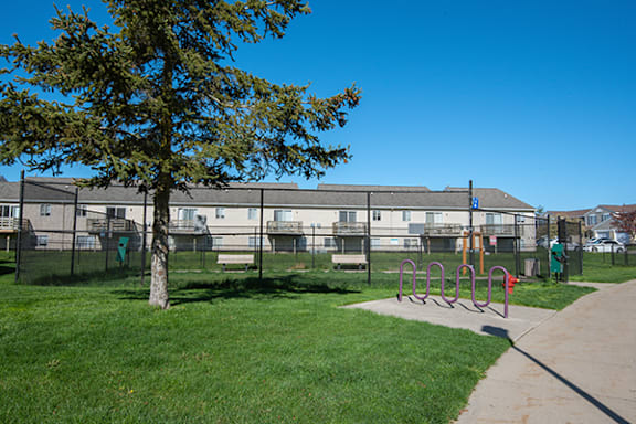 a dog park in front of an apartment building