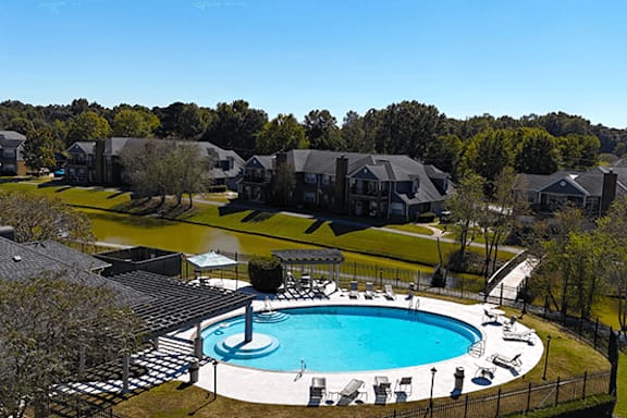 an aerial view of a swimming pool with houses in the background