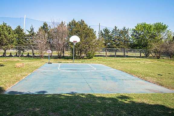 A basketball court with a net and a basketball hoop.