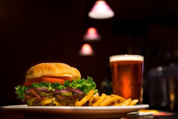 a plate with a sandwich and fries and a glass of beer