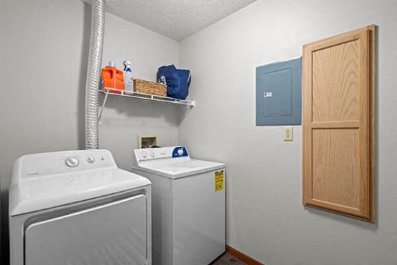 a white laundry room with a washer and a dryer