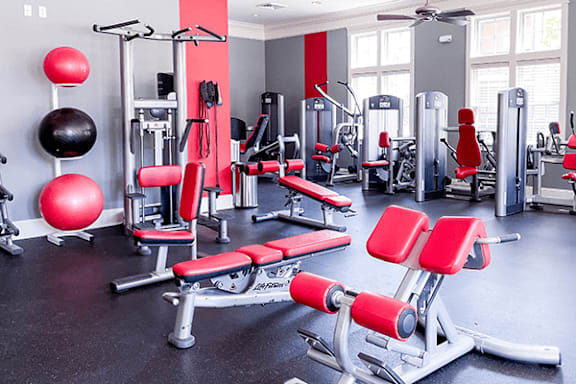 A gym with red and black equipment.