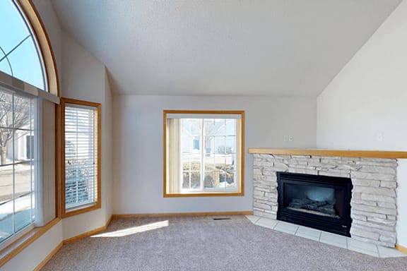A room with a fireplace and a window.