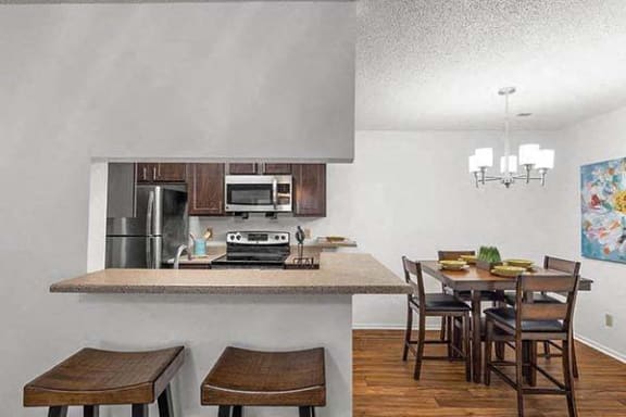 a kitchen with a bar and a dining table