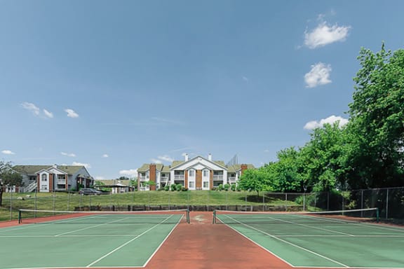 a tennis court at country club apartments in Toledo