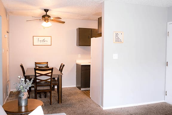 A dining room with a table and chairs.