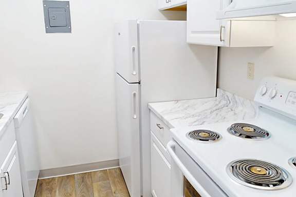 A small kitchen with a white stove top oven.