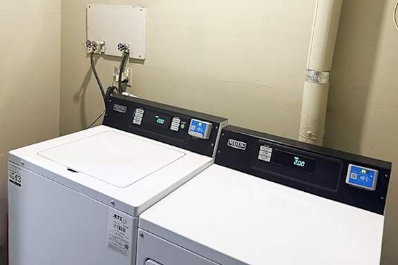 A washing machine with a digital display and a control panel.