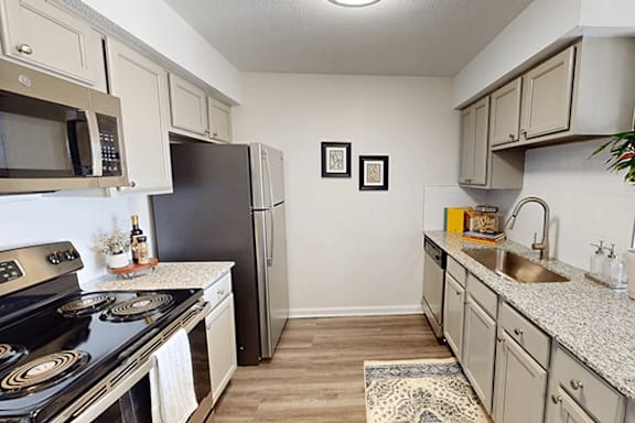 a kitchen with stainless steel appliances and granite counter tops