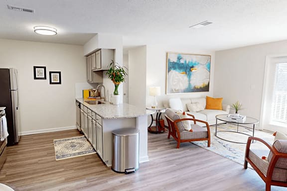 a living room with a kitchen and a couch