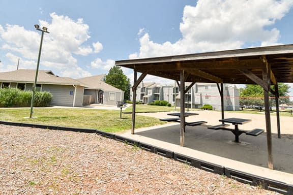 a picnic area with benches and tables in a park
