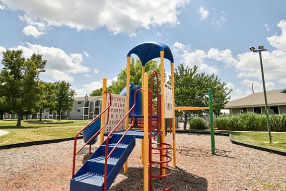 a playground with a blue and yellow slide