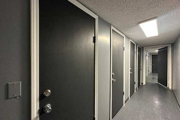 A long hallway with storage units for resident use