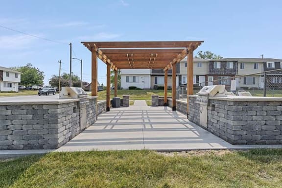 a stone walkway with a wooden structure on top of it