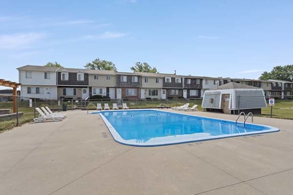 a large swimming pool in front of a building