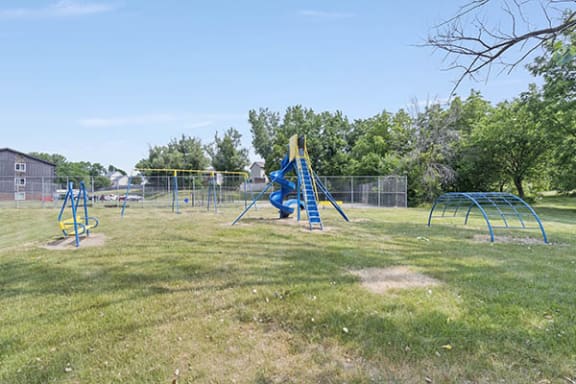 a playground with a swing set and monkey bars