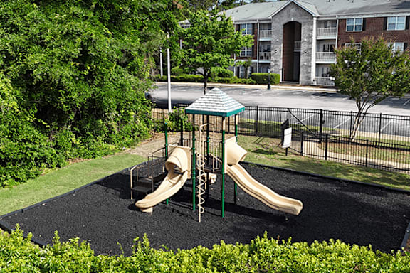 A playground with a slide and a swing set.