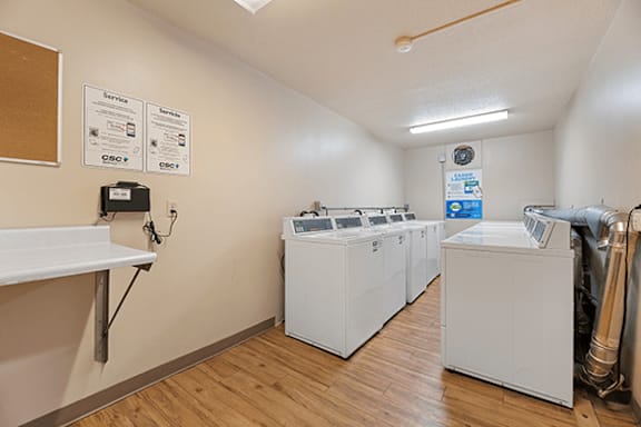 A laundry room with washers and dryers.