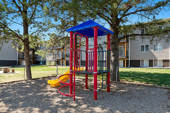 A red and blue playground structure with a yellow slide.