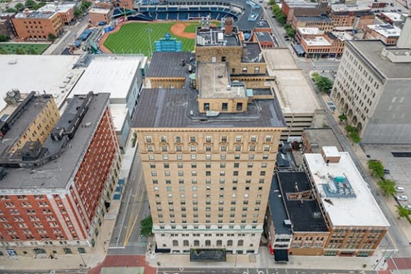 an aerial view of a city with buildings and a baseball field