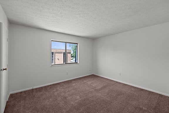 Empty room with a window and a door.