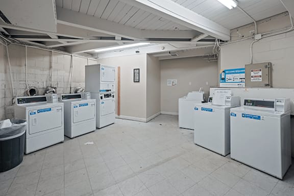 A laundry room with washers and dryers.