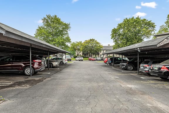 a parking lot with cars parked under roofs