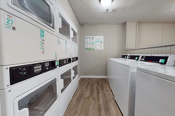 A row of washing machines in a public laundromat.